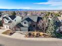 Stunning two-story home boasts a landscaped front yard, attached garage and mountain views at 853 Huntington Dr, Highlands Ranch, CO 80126