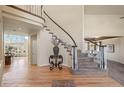 Bright foyer with hardwood floors and a staircase featuring a curved design and wrought iron balusters at 853 Huntington Dr, Highlands Ranch, CO 80126