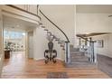 Spacious foyer featuring a curved staircase, hardwood floors, and an elegant entryway table at 853 Huntington Dr, Highlands Ranch, CO 80126