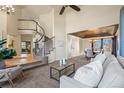 Open concept living room and dining area featuring vaulted ceiling, staircase and contemporary decor at 853 Huntington Dr, Highlands Ranch, CO 80126