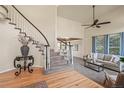 Inviting living room featuring a curved staircase, fan, neutral colors, and lots of natural light at 853 Huntington Dr, Highlands Ranch, CO 80126