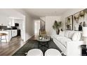 Bright living room with modern furnishings, an open floor plan, and seamless flow to the kitchen at 9316 W Utah Ave, Lakewood, CO 80232