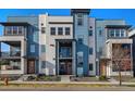 Modern townhome showcasing a three-story facade with varied textures and complementary blue and gray hues at 1565 W 67Th Ave, Denver, CO 80221