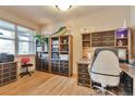 Bright home office featuring custom built-ins, hardwood flooring, and ample natural light at 2686 S Cherokee St, Denver, CO 80223