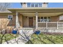 Inviting front porch with classic columns and a pathway leading to the entrance at 2692 N Raleigh St, Denver, CO 80212