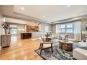 Bright living room featuring hardwood floors, an open floor plan, and large windows with plenty of natural light at 2692 N Raleigh St, Denver, CO 80212