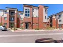 Modern condo with brick facade and multiple balconies in a convenient neighborhood setting at 14301 E Tennessee Ave # 109, Aurora, CO 80012