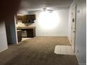 Spacious living room with carpet, tile entry, a ceiling fan, and access to the kitchen at 16359 W 10Th Ave # 1, Golden, CO 80401
