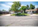 Classic ranch home boasts an attached one-car garage and manicured front lawn, enhancing its curb appeal at 2294 W Parkhill Ave, Littleton, CO 80120