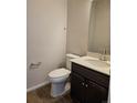 Powder room with a modern vanity, sink, and toilet at 6046 Keyser Pl, Brighton, CO 80601