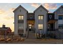 Stylish two-story home with a covered porch, featuring modern design elements and an inviting entrance at 242 Clementina St, Louisville, CO 80027