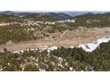 Expansive aerial view of property, showcasing the landscape, neighboring homes, and mountain views at 25019 N Mountain Park Dr, Evergreen, CO 80439