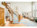Elegant foyer with hardwood floors, curved staircase, and open layout at 17705 W 63Rd Dr, Golden, CO 80403
