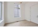 Bright bedroom with hardwood floors, fresh white paint, and a window that allows natural light at 710 Belay St, Erie, CO 80516