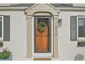 Welcoming front door framed by brick accents and adorned with a wreath, enhancing curb appeal at 2830 Forest St, Denver, CO 80207