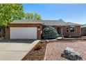 Beautiful brick home with a two-car garage and a well-maintained front yard at 2072 Skylark Ct, Longmont, CO 80503