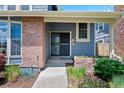 A welcoming front porch with brick accents invites you into this beautiful residence at 7659 S Rosemary Cir, Centennial, CO 80112