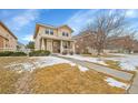 Charming two-story home with well-manicured lawn in a Gathering-friendly neighborhood on a sunny day at 23601 E Mississippi Cir, Aurora, CO 80018