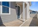 Exterior shows small patio area with door and window at 23744 E Ida Pl # E, Aurora, CO 80016
