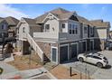 Multi-level home featuring attached garages and stone accents at 23744 E Ida Pl # E, Aurora, CO 80016