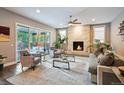 Inviting living room with stone fireplace, plush seating, hardwood floors, and sliding doors to the patio at 445 Forest St, Denver, CO 80220