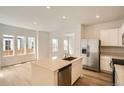 Bright, open-concept kitchen with stainless steel appliances and large island at 15228 Detroit St, Thornton, CO 80602