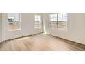 Bright living room with hardwood floors and lots of natural light from windows at 15228 Detroit St, Thornton, CO 80602