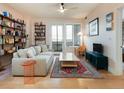 Inviting living room with hardwood floors, floor to ceiling bookshelves, comfortable seating, and natural light at 3701 Arapahoe Ave # 304, Boulder, CO 80303