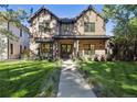 Charming brick home featuring a well-manicured lawn and inviting walkway that leads to the front entryway at 2511 S Columbine St, Denver, CO 80210