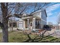 Charming two-story home with a welcoming front porch, a well-manicured lawn, and a two-car garage at 11671 Elkhart, Brighton, CO 80603