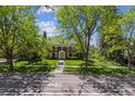 Charming brick home with lush lawn and mature trees; welcoming curb appeal at 2222 E 7Th Avenue Pkwy, Denver, CO 80206