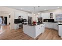 Spacious kitchen with white cabinets, black granite countertops, and stainless steel appliances at 8389 Owl Roost Ct, Parker, CO 80134