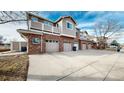 Townhouse exterior with multiple garages and a spacious driveway at 8865 Federal Blvd # 202, Westminster, CO 80260