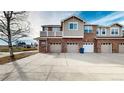 Townhouse exterior showcasing a brick facade and attached garage at 8865 Federal Blvd # 202, Westminster, CO 80260