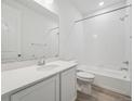 Well-lit bathroom featuring a shower-tub combo, a modern vanity with storage, and sleek fixtures at 45916 Gentry Ave, Bennett, CO 80102