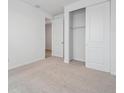 Cozy bedroom with neutral carpet, a closet with sliding doors, and ample natural light at 45916 Gentry Ave, Bennett, CO 80102