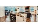 Bright kitchen with wood countertops, white cabinets, and a stainless steel farmhouse sink at 2286 S Pitkin Way # A, Aurora, CO 80013
