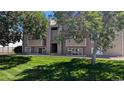 Exterior shot of building with number 19 in the center, and large trees framing the sides of the building at 10150 E Virginia Ave # 308, Denver, CO 80247