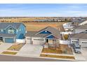 Ranch-style home, two-car garage, and a view of the neighborhood and a pond at 2420 Nicholson St, Berthoud, CO 80513