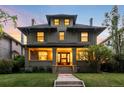 Beautiful two-story home featuring a covered front porch with detailed columns and manicured landscaping at 637 N Franklin St, Denver, CO 80218