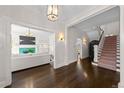Open-concept living area with hardwood flooring and seamless access to the staircase at 637 N Franklin St, Denver, CO 80218