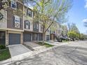 Charming townhomes with attached garages line the street, displaying varied exterior finishes and appealing features at 2578 E Nichols Cir, Centennial, CO 80122