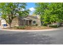 Beautifully landscaped exterior with mature trees, a charming entrance, and a two-car garage at 2090 S Fairplay St, Aurora, CO 80014