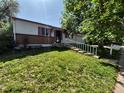 Exterior of a single Gathering home featuring a long concrete driveway and mature trees at 3984 S Pitkin Way, Aurora, CO 80013