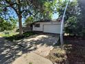 Home featuring a front-facing two-car garage, and a lawn with mature trees needing some TLC at 3984 S Pitkin Way, Aurora, CO 80013