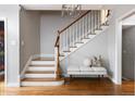 Beautiful wooden staircase with white risers, hardwood floors, and a light gray wall color at 30 Eudora St, Denver, CO 80220