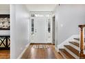 Open foyer with a bright entryway, hardwood floors, and stylish console table with modern art at 30 Eudora St, Denver, CO 80220