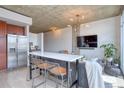 Open concept living and dining room area with concrete ceilings and modern finishes at 1700 Bassett St # 412, Denver, CO 80202