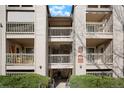 Well-maintained apartment building entrance featuring stairwells and multiple levels with balconies at 9212 E Arbor Cir # E, Englewood, CO 80111