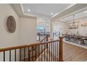 Elegant entryway with hardwood floors, staircase with iron railings, and views of the dining and living areas at 8016 Gore Creek Ln, Littleton, CO 80125